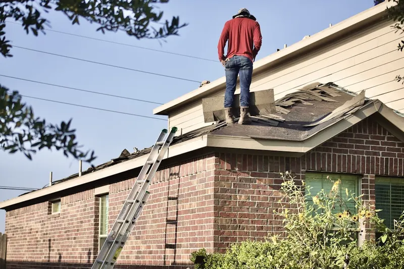Professional roofer working on a residential roof in Marne